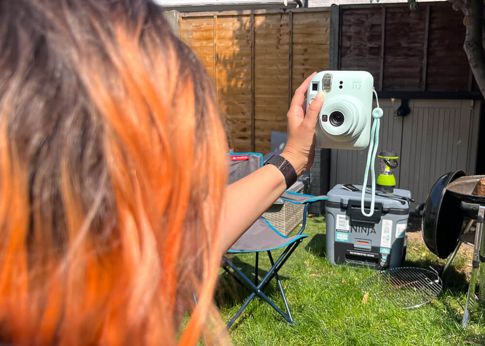 Girl taking selfie with Instax mini camera