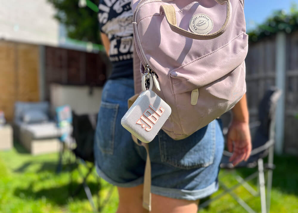 JBL Portable speaker hanging from a backpack