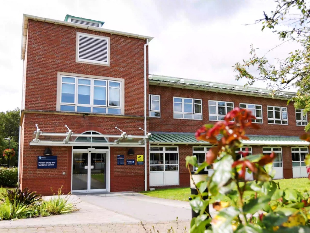The Peirson Study and Guidance Centre, a red-bricked building shown with flowers in the foreground